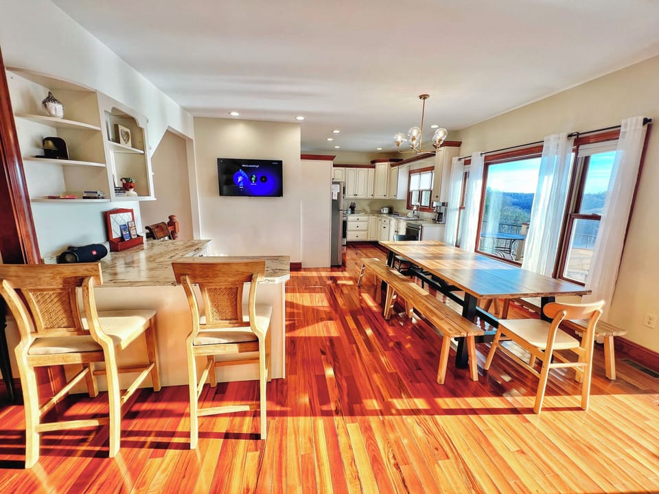 The open kitchen is well stocked & has a view to enjoy. 1 of the 3 Smart TVS.