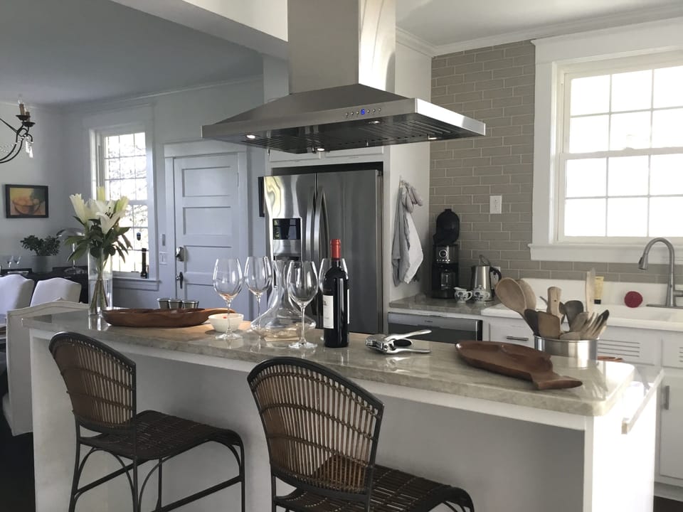 Modern stainless appliances are surrounded by Taj Mahal countertops.