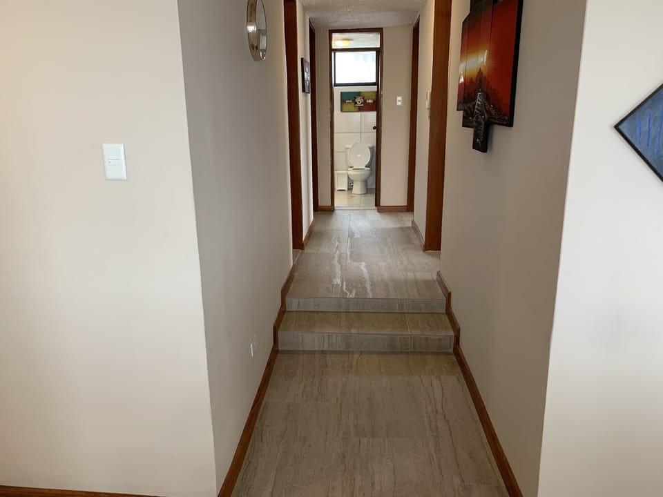 Hallway to 4 bedrooms and bathroom.