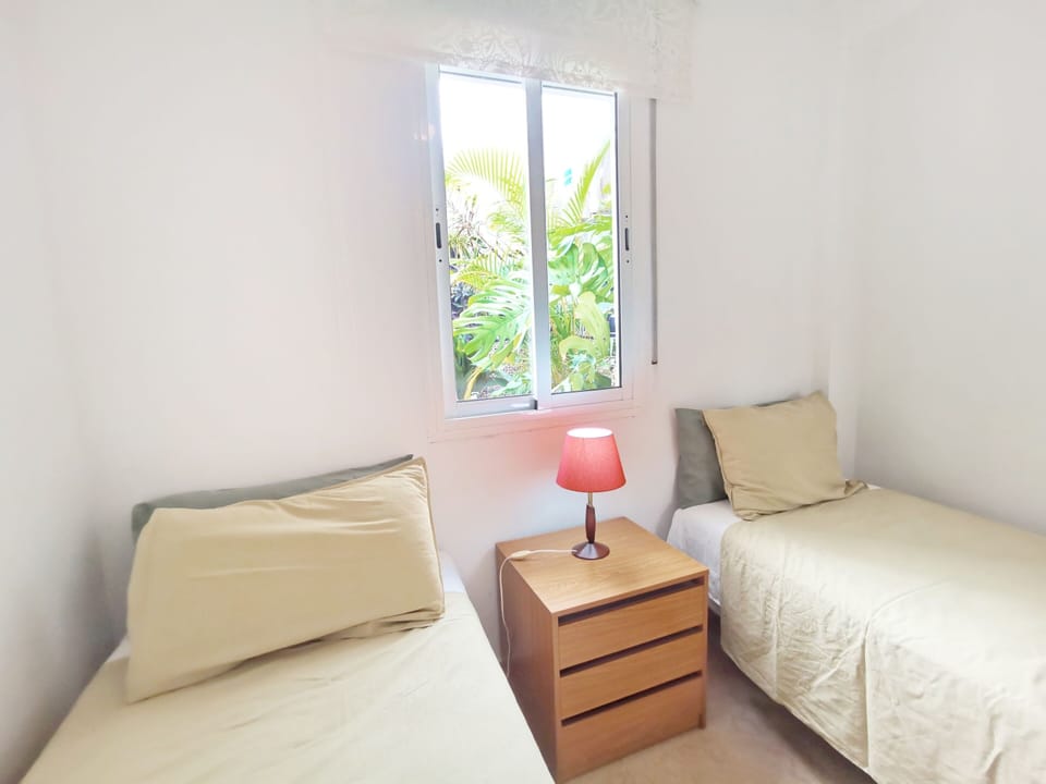 2 single beds, view to inner Patio