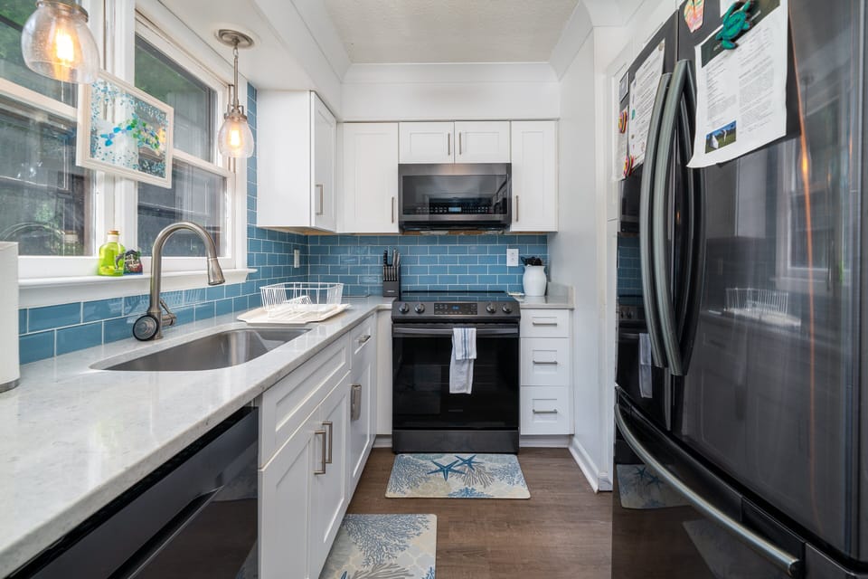 Stainless steel appliances, custom cabinets, tiled backsplash!