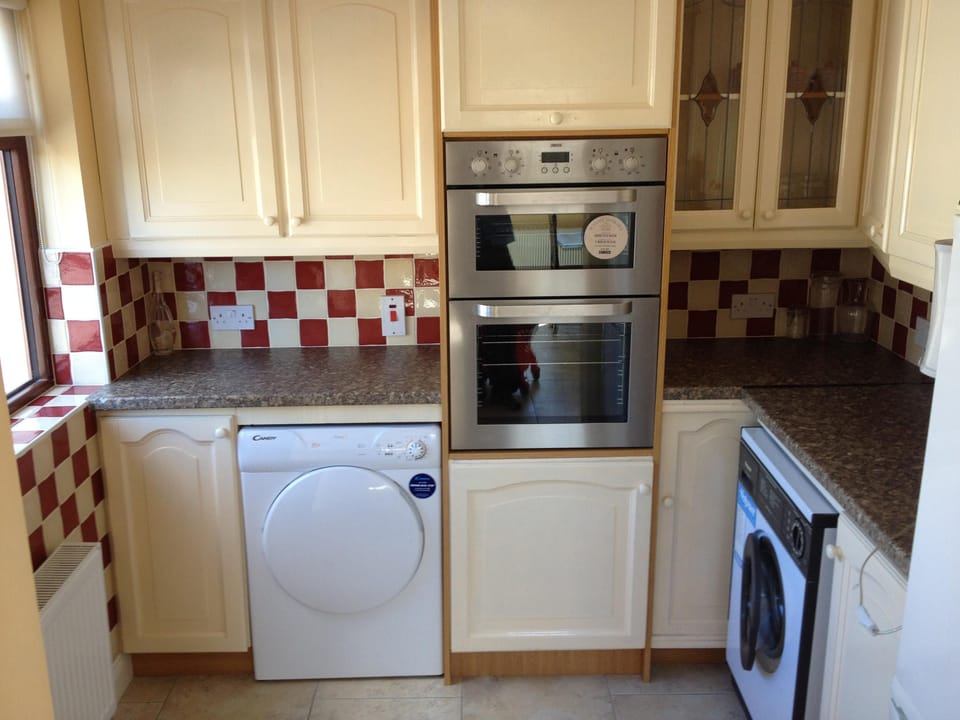 back kitchen, oven, laundry, fridge.