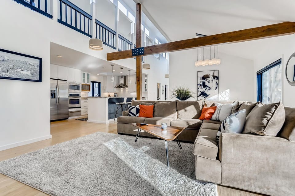 Living room with high ceilings and view of upstairs and loft area