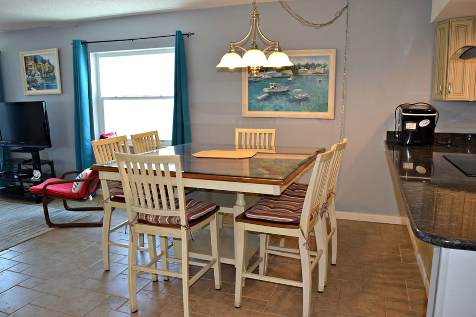 Between kitchen and living room is this large dining table, with a nice tile floor.