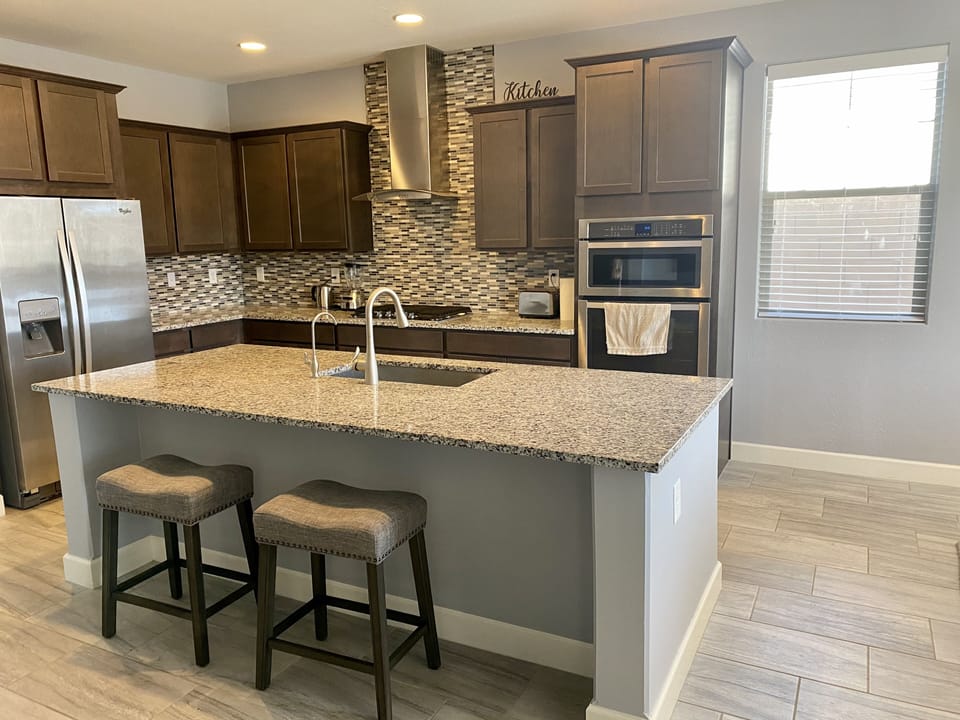 Kitchen with Granite Countertops and Stainless Steel Appliances 