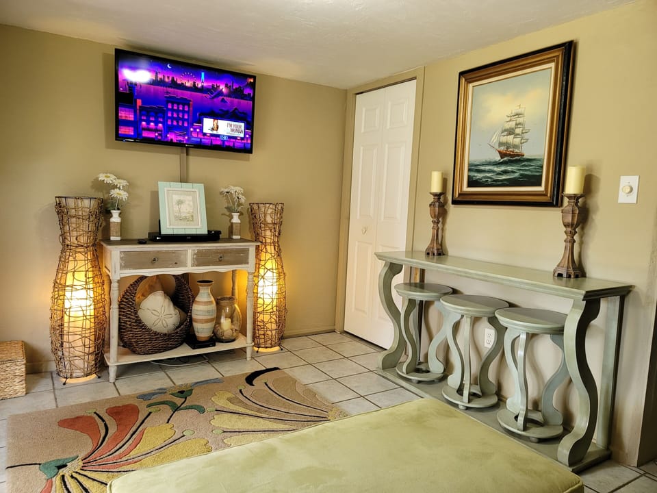 A bar table with 3 stools for the kids to grab snacks and watch Netflix 