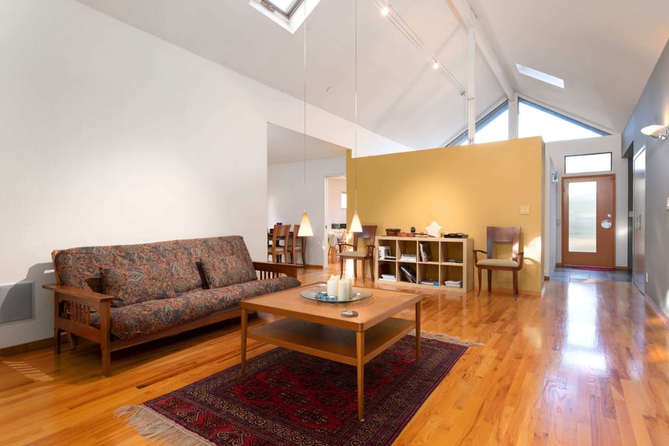 We start our tour of this delightful home with one picture for each of the rooms.  After that, we'll do another tour, with more pictures.  Starting here in the expansive & bright living area, with vaulted ceilings.