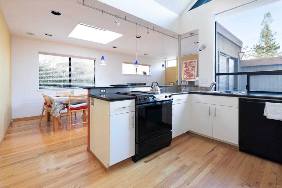 The kitchen is well-appointed, with granite countertops and all the appliances and kitchenware you need.