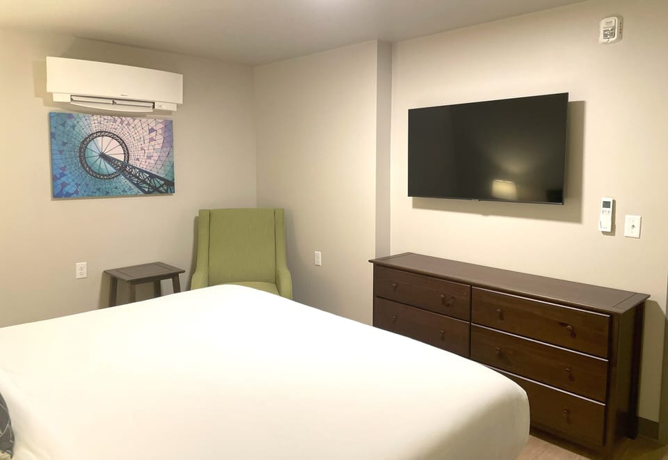 Bedroom in Apartment 208 with flat screen television