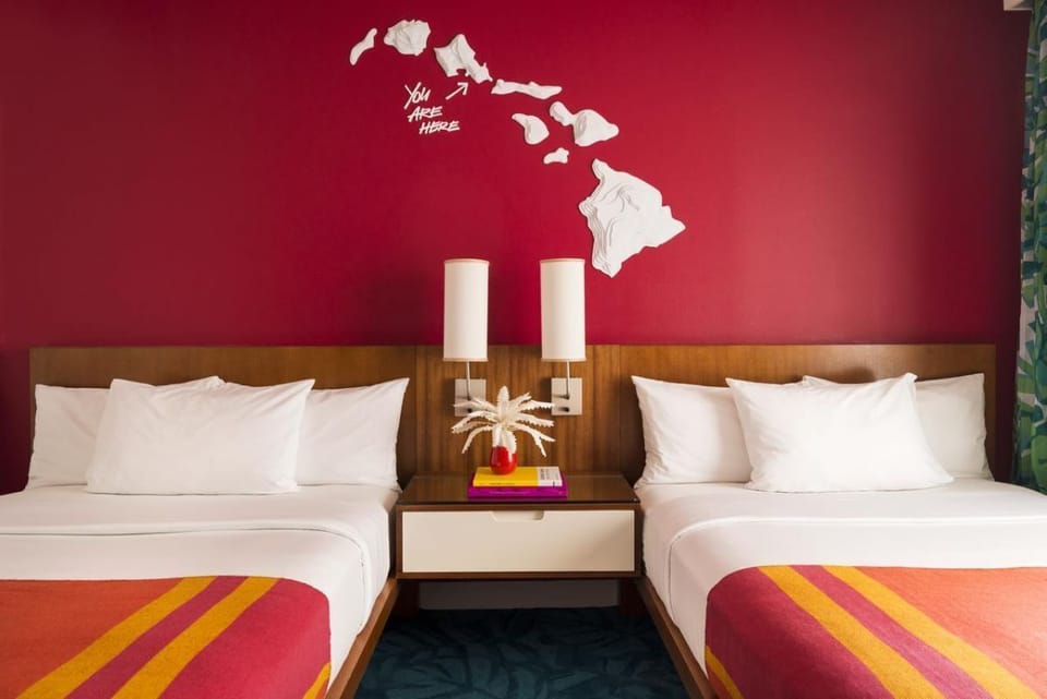 Unwind together in bright double beds with island-inspired colors.