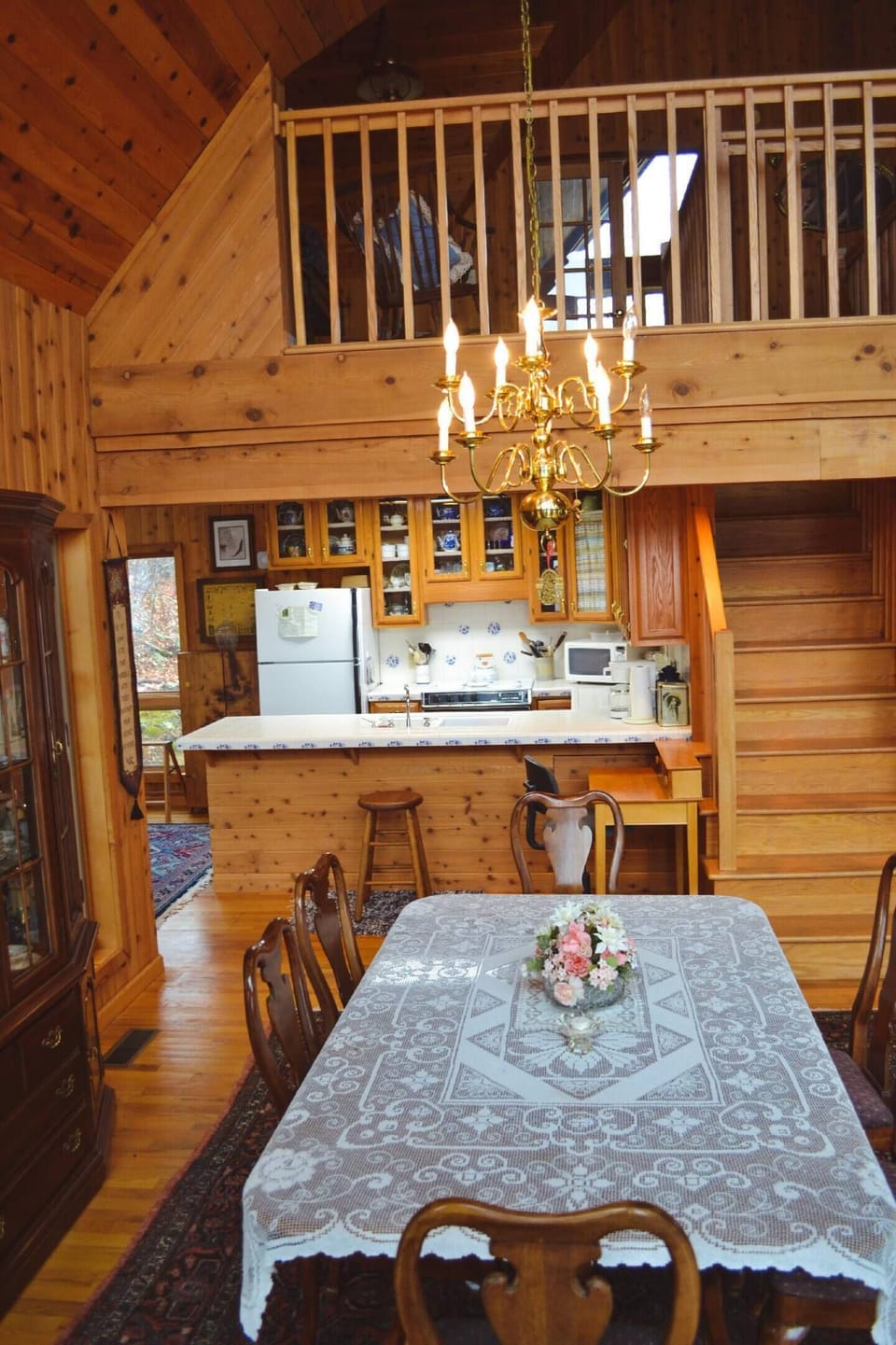A formal dining room table overlooks the den's fireplace, and kitchen keeping the whole family involved in a "great room"