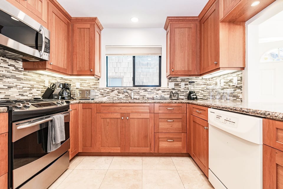 Kitchen comes stocked with dishes, utensils, cookware, bakeware, and large and small appliances.
                