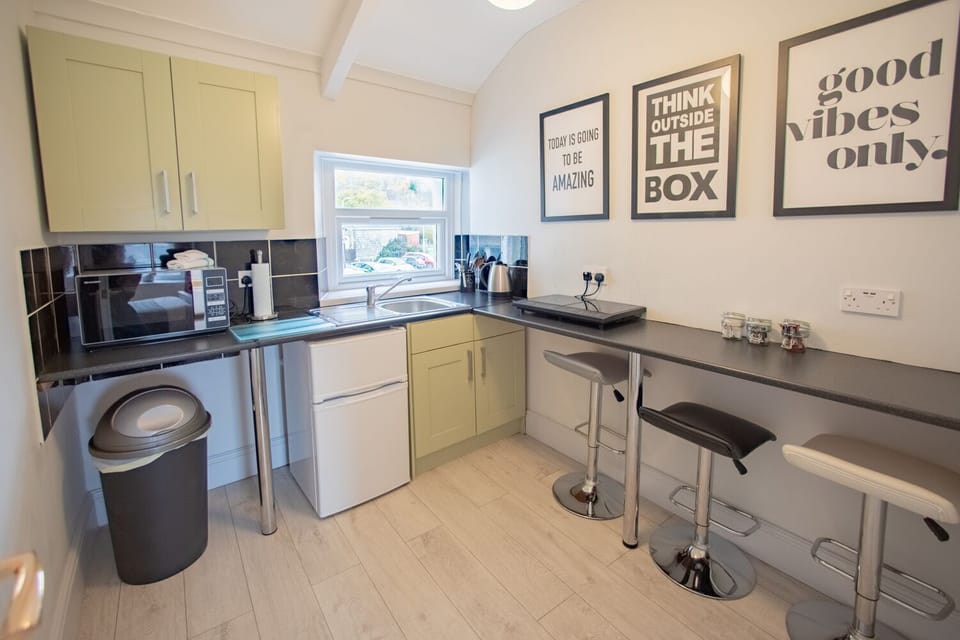 The kitchenette features all essentials, including a toaster, kettle, and hob.
