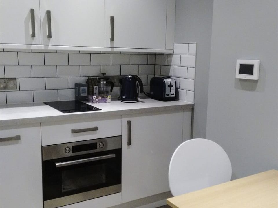 Kitchenette with microwave/oven, dishwasher, table and fridge