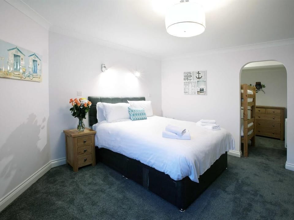 apartment 1,master bedroom/ bunkbed area through arch way