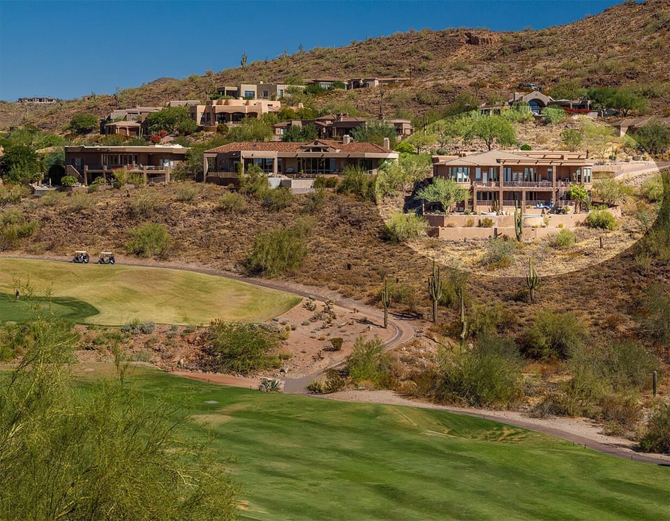View of house from golf course and canyon