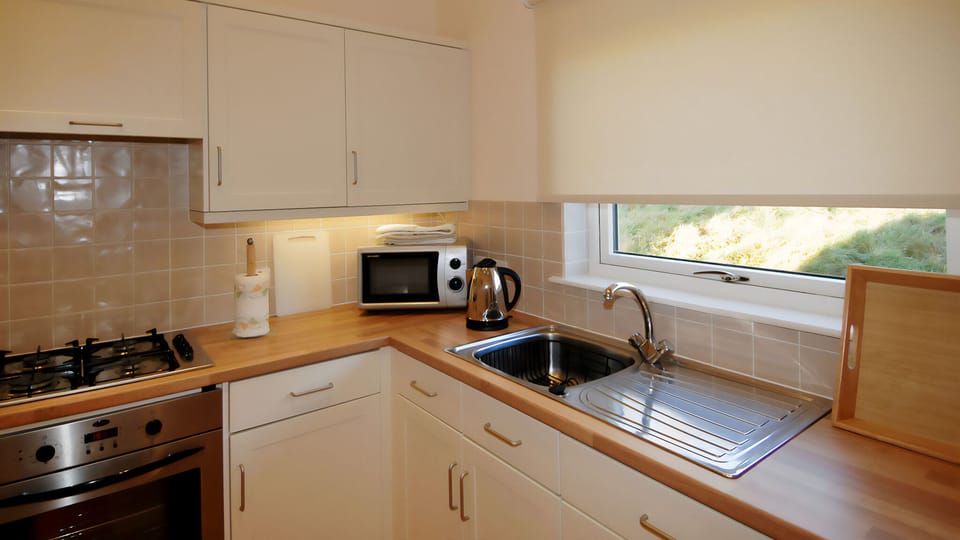 Full set of appliances (refrigerator, kettle, toaster, microwave, oven)