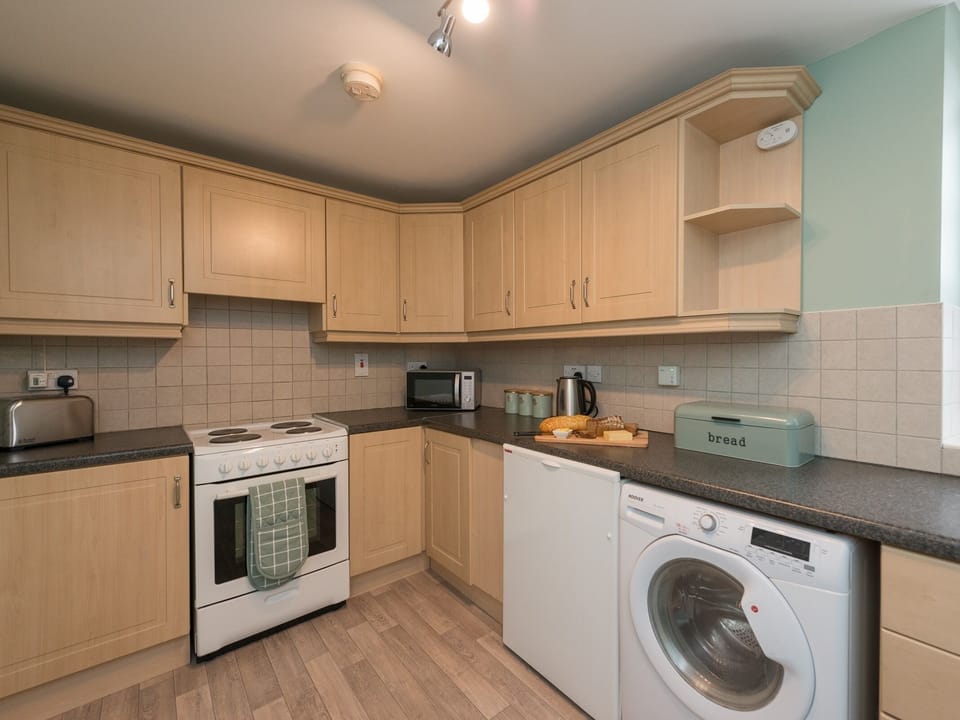 Full kitchen including coffee machine.