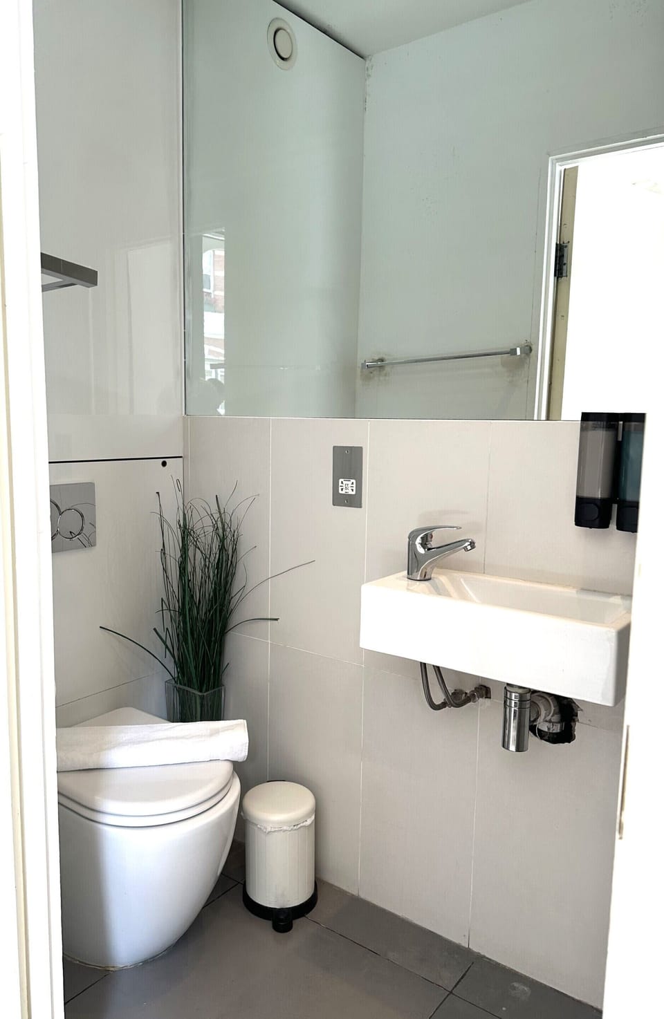 Comfortable standard toilet with shower, shampoo, conditioner, hand wash, and toilet paper for your convenience.
