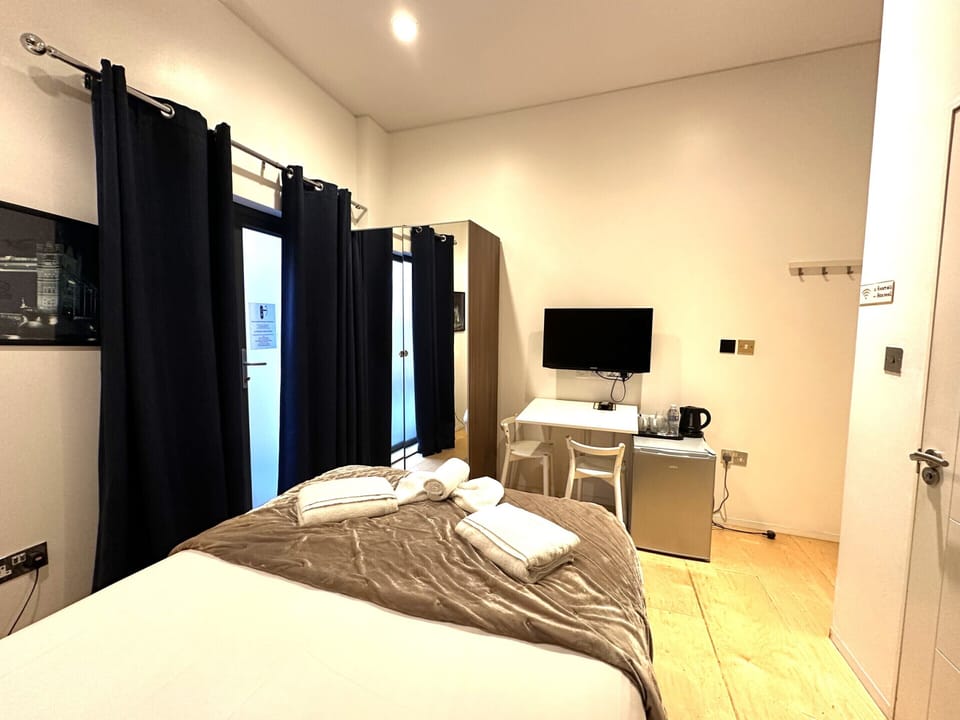 A double room with private bathroom and balcony, featuring a standard double bed for comfort.