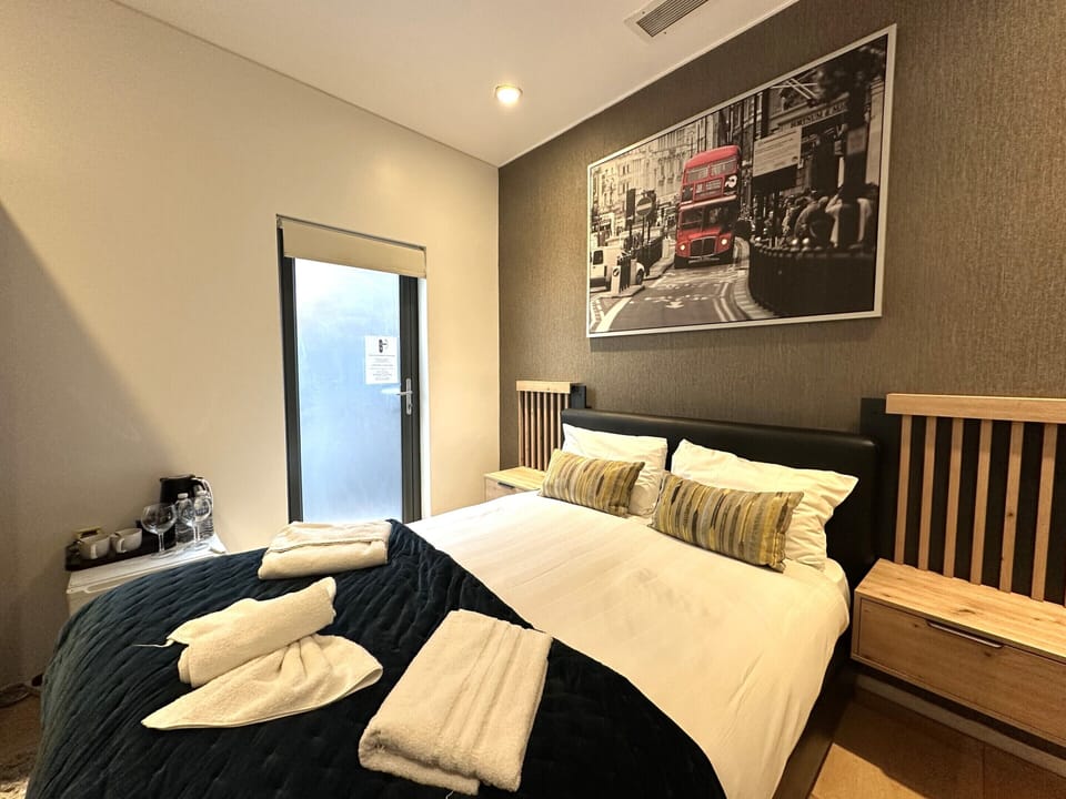 A double room with private bathroom and balcony, featuring a standard double bed for comfort.