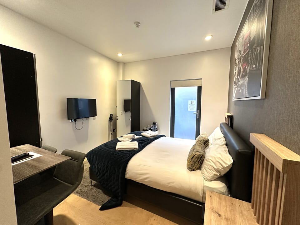 A double room with private bathroom and balcony, featuring a standard double bed for comfort.