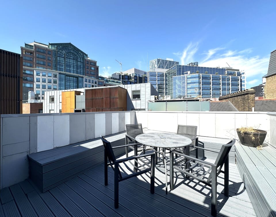 Spacious terrace with seating area and stunning city views from the top floor