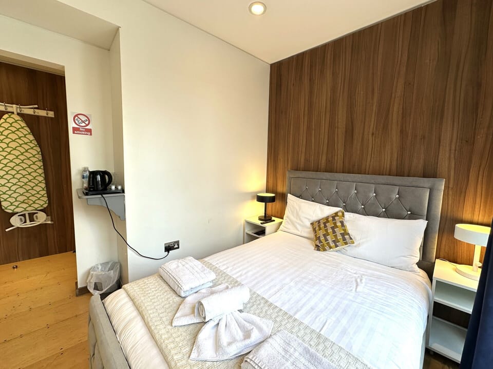 Comfortable double room featuring a private bathroom, a cosy small balcony, and a spacious double bed for a restful stay.