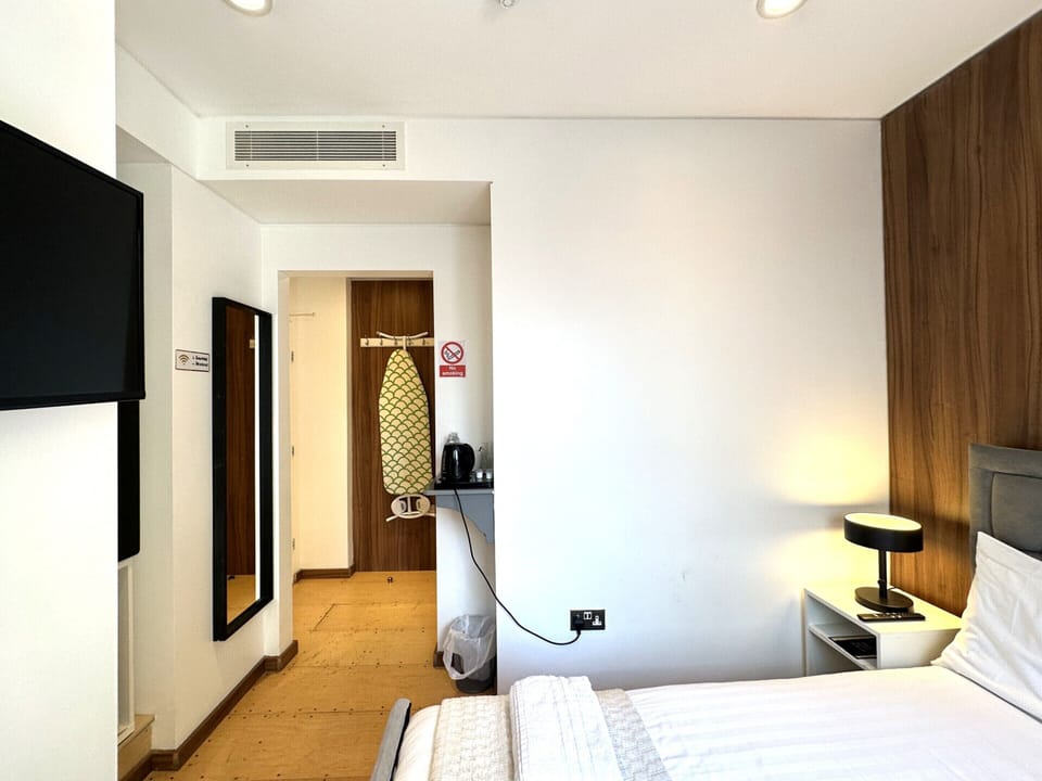 Comfortable double room featuring a private bathroom, a cosy small balcony, and a spacious double bed for a restful stay.