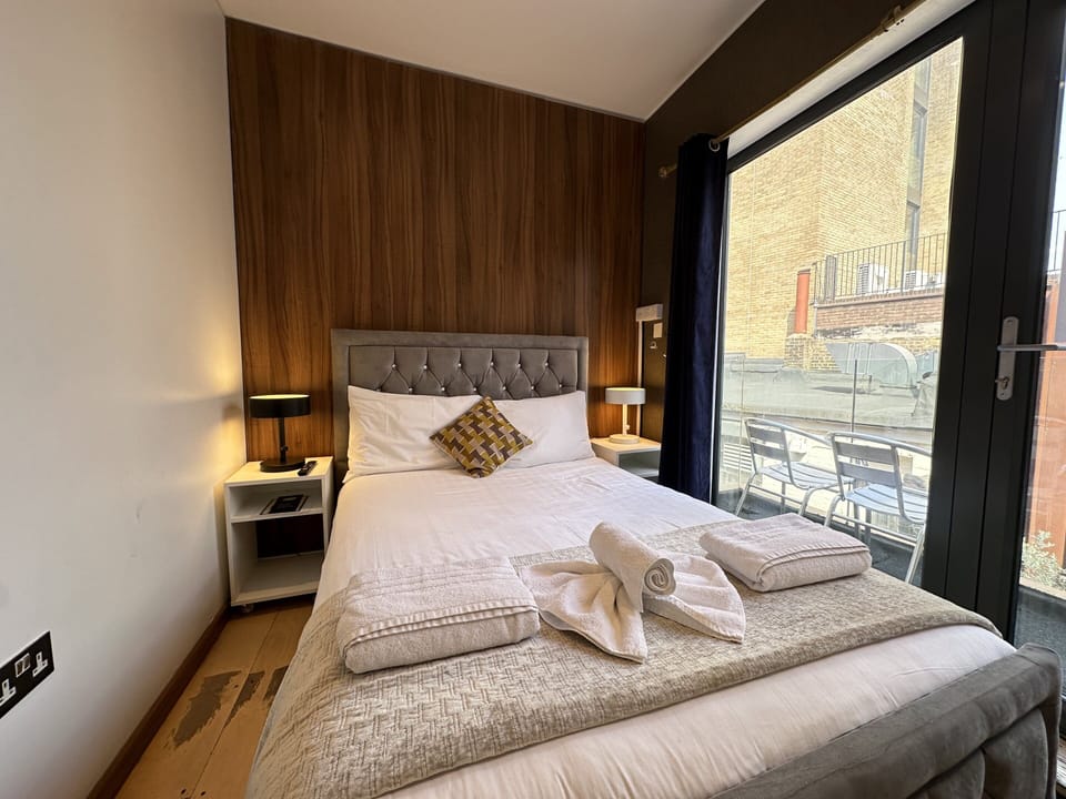 Comfortable double room featuring a private bathroom, a cosy small balcony, and a spacious double bed for a restful stay.