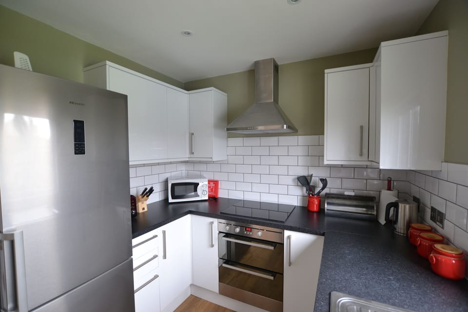 Fully fitted kitchen with oven, hob, microwave, toaster, fridge freezer and slimline dishwasher