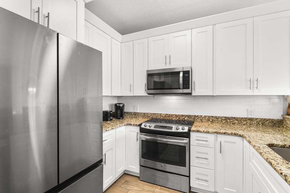 Your fully equipped kitchen awaits with granite counters, stainless appliances, and everything needed for home-cooked meals.