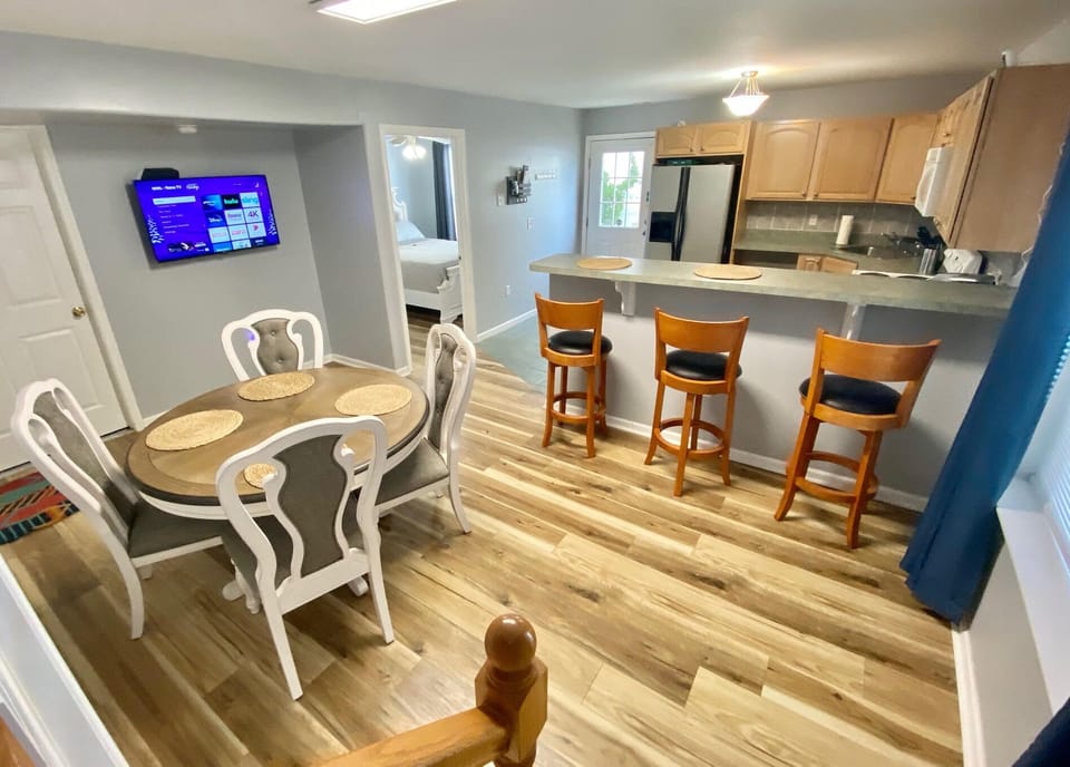 Full kitchen n with 3 counter height chairs. 43" smart TV