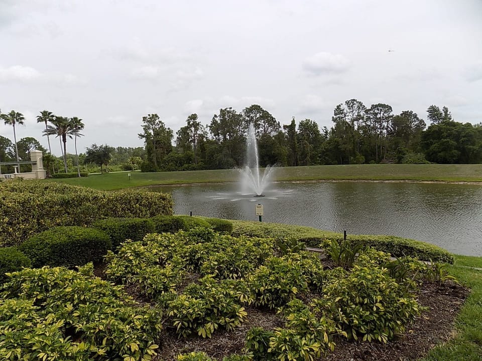 Nature pond with a fountain behind club house