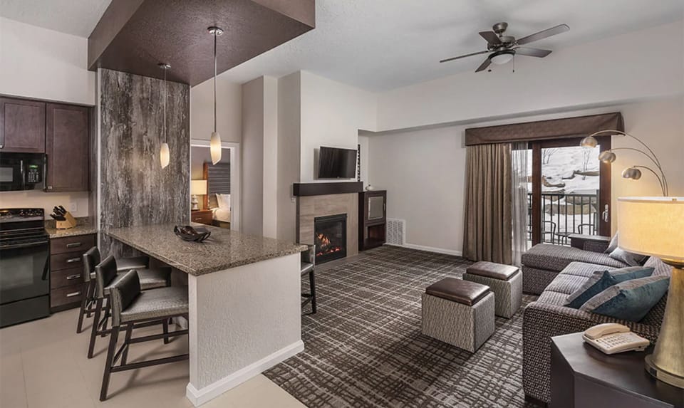 Living Room with fireplace, balcony, and queen pullout sofa