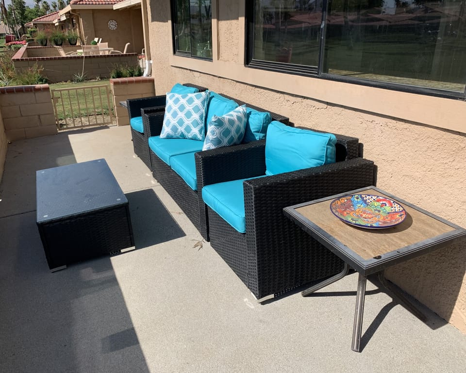 More back patio seating with retractable awning. Fire pit.