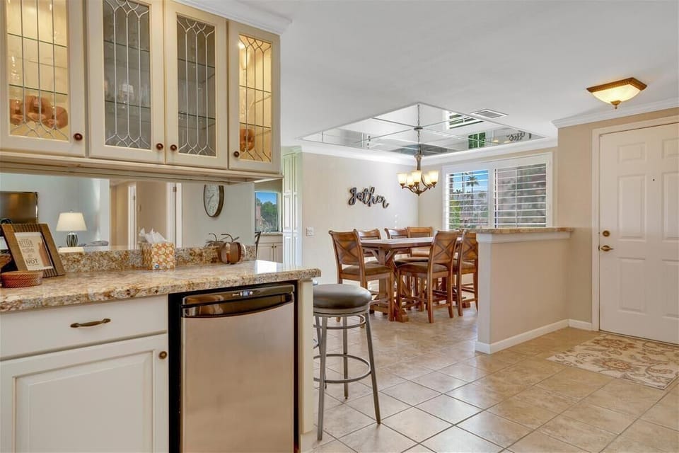 Wet bar with fridge and dining area.