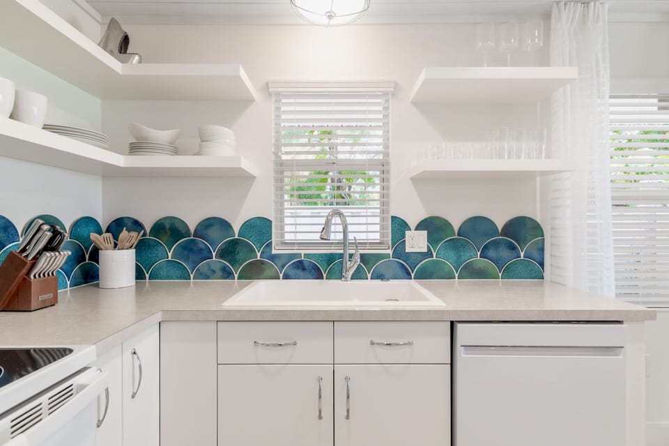 Watercolored handmade, hand glazed clay tiles are the focal point of the kitchen.