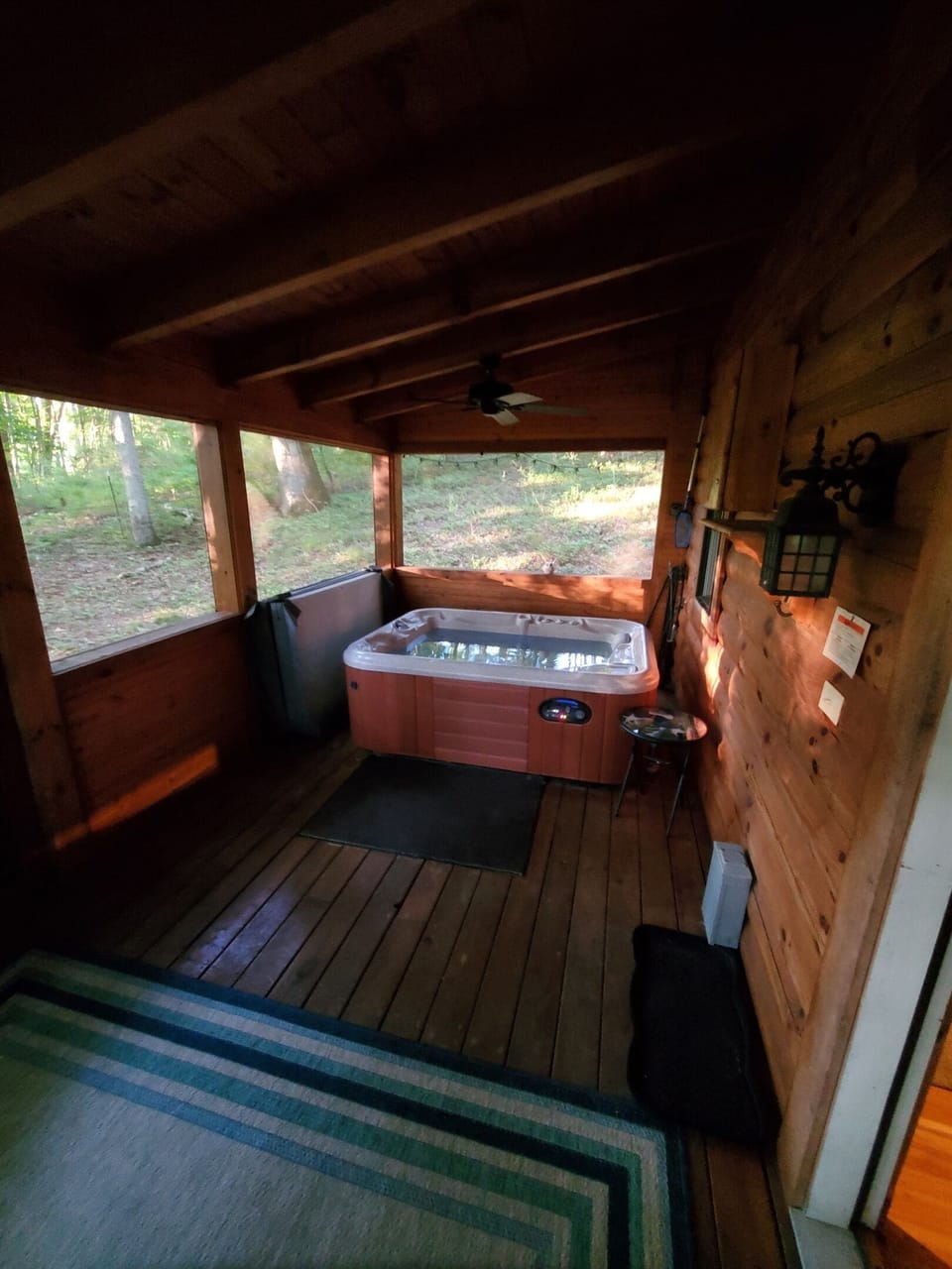Tucked away on the screened cedar porch, the hot tub provides a serene, private spot for relaxing soaks.