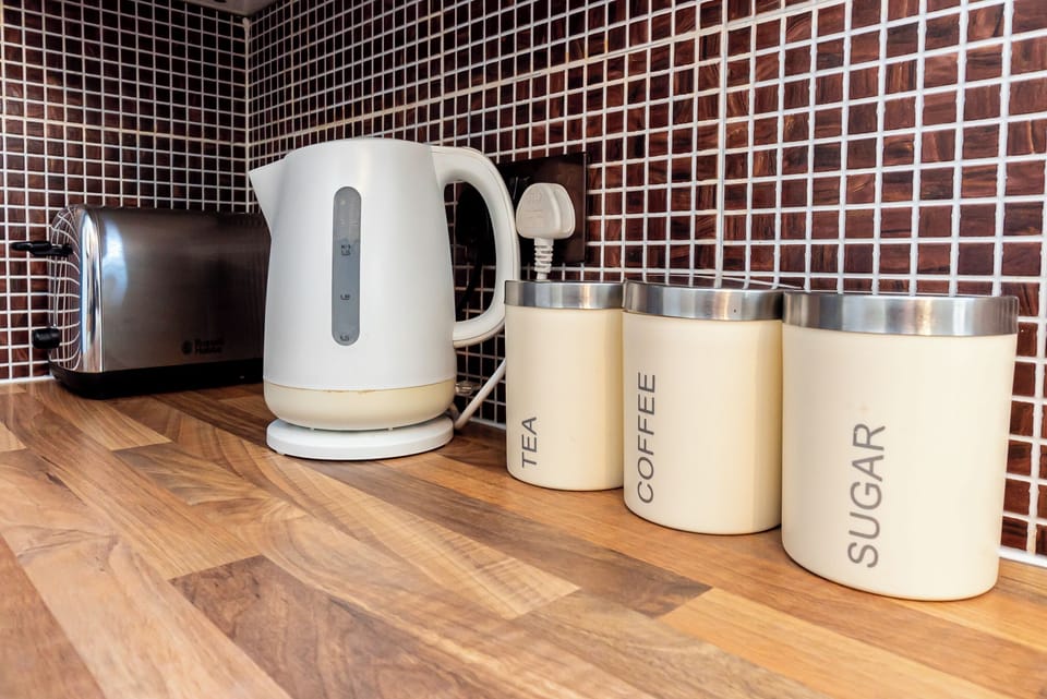 Kitchenette Delight: Whip up morning magic with stylish appliances and charming storage!