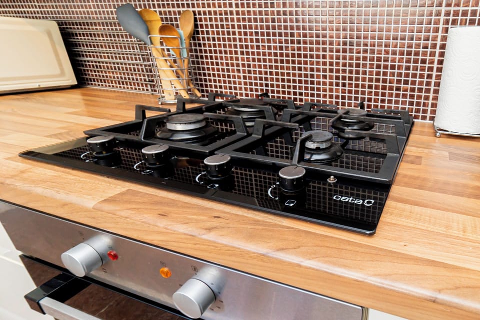 Kitchen: Whip up culinary masterpieces on this sleek, modern gas stove with stylish accents!