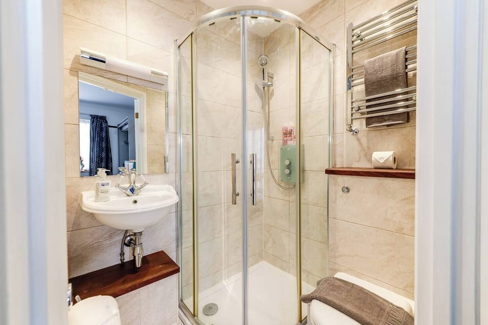 Bathroom Oasis: Enjoy a refreshing rainfall shower and elegant touches for your perfect escape!