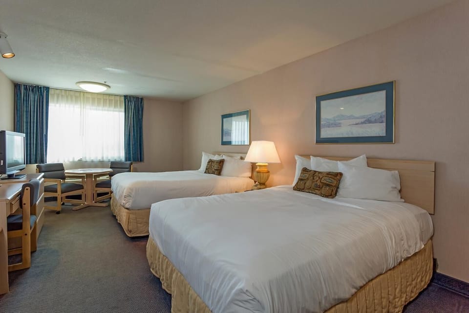 Sink into crisp linens under warm, calming bedside light.