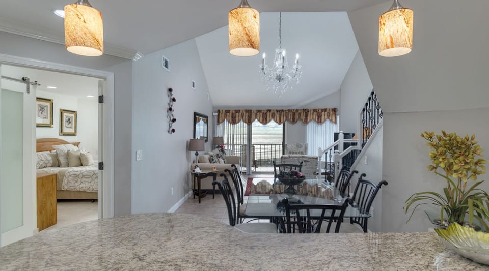area is arranged for easy conversation and movie nights, while the open staircase adds architectural interest without interrupting the sightlines.