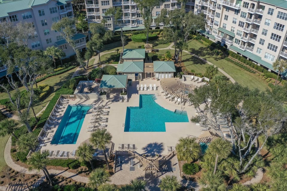 An aerial view showcases the resort-style amenities at Hampton Place, featuring a beautifully designed oceanfront pool complex.