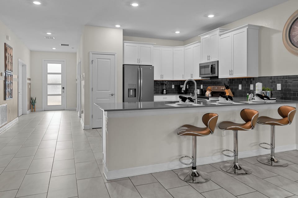 Your fully equipped kitchen features modern appliances, granite counters, and a breakfast bar perfect for casual meals.