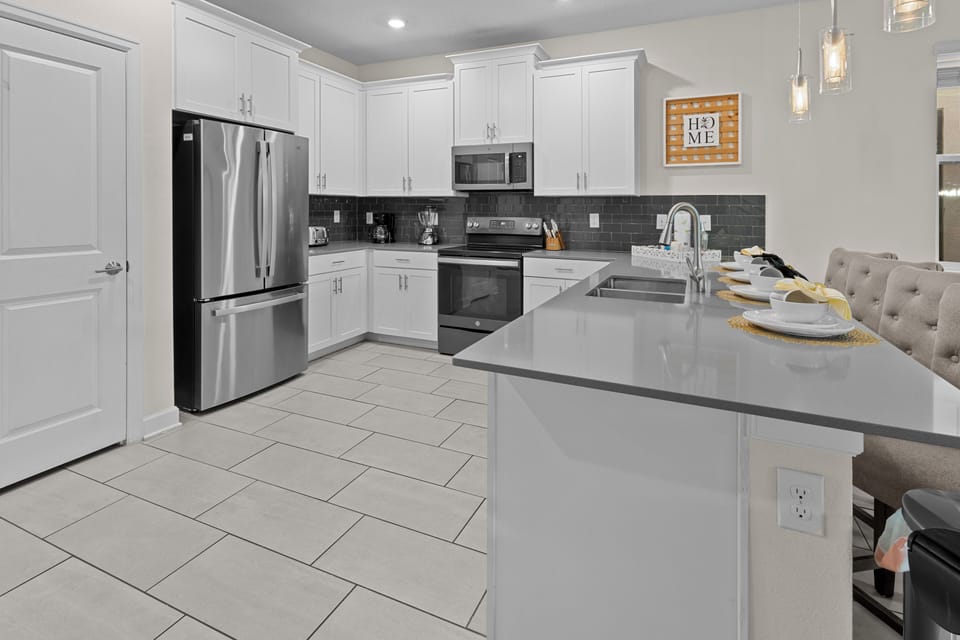 Your fully equipped kitchen features stainless steel appliances, quartz counters, and everything you need for memorable meals together.