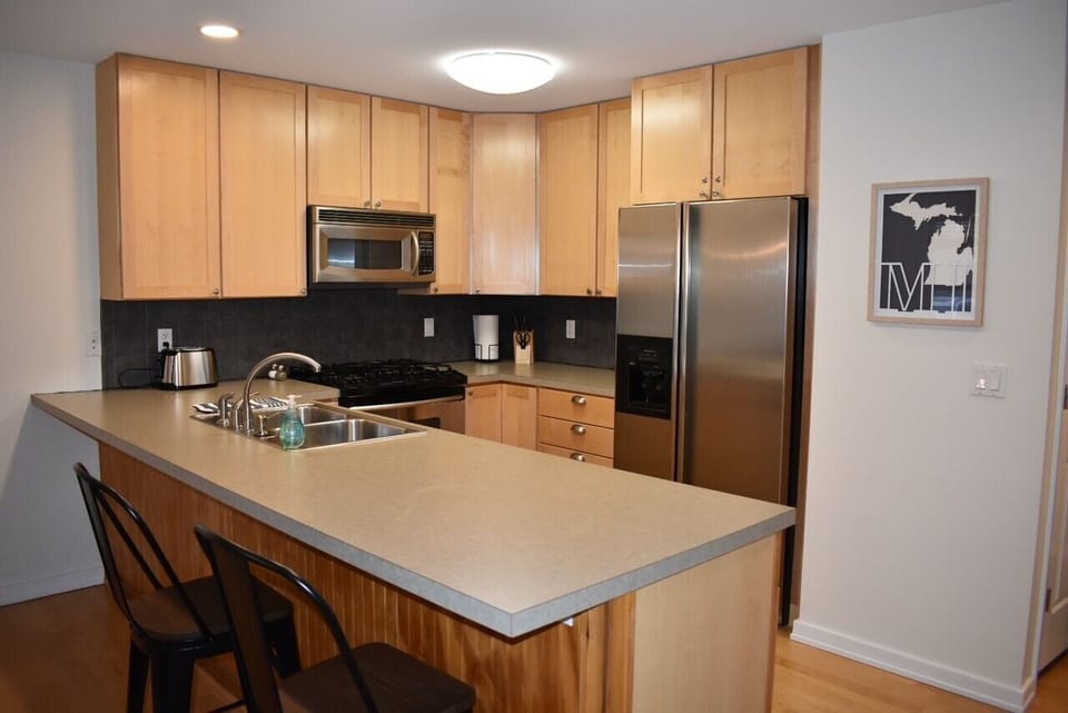 Fully stocked kitchen with two bar stools