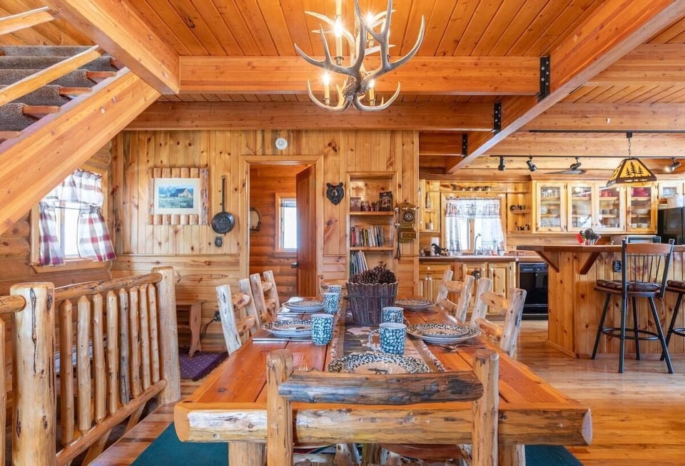 You will find Beautiful Rustic Charm throughout the cabin.  Plenty of room to dine at this sturdy table  with  room for four more at the kitchen bar.