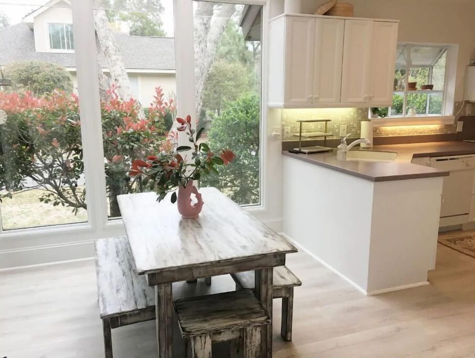 Kitchen table (custom made) in spacious open nook,  seats 6-8. TV above table.
